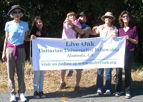 Live Oak UU members holding church banner on Mt. Diablo