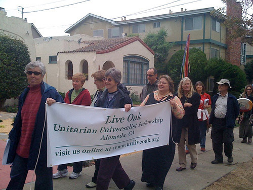 Live Oak members carrying banner at Coming Out Day celebration